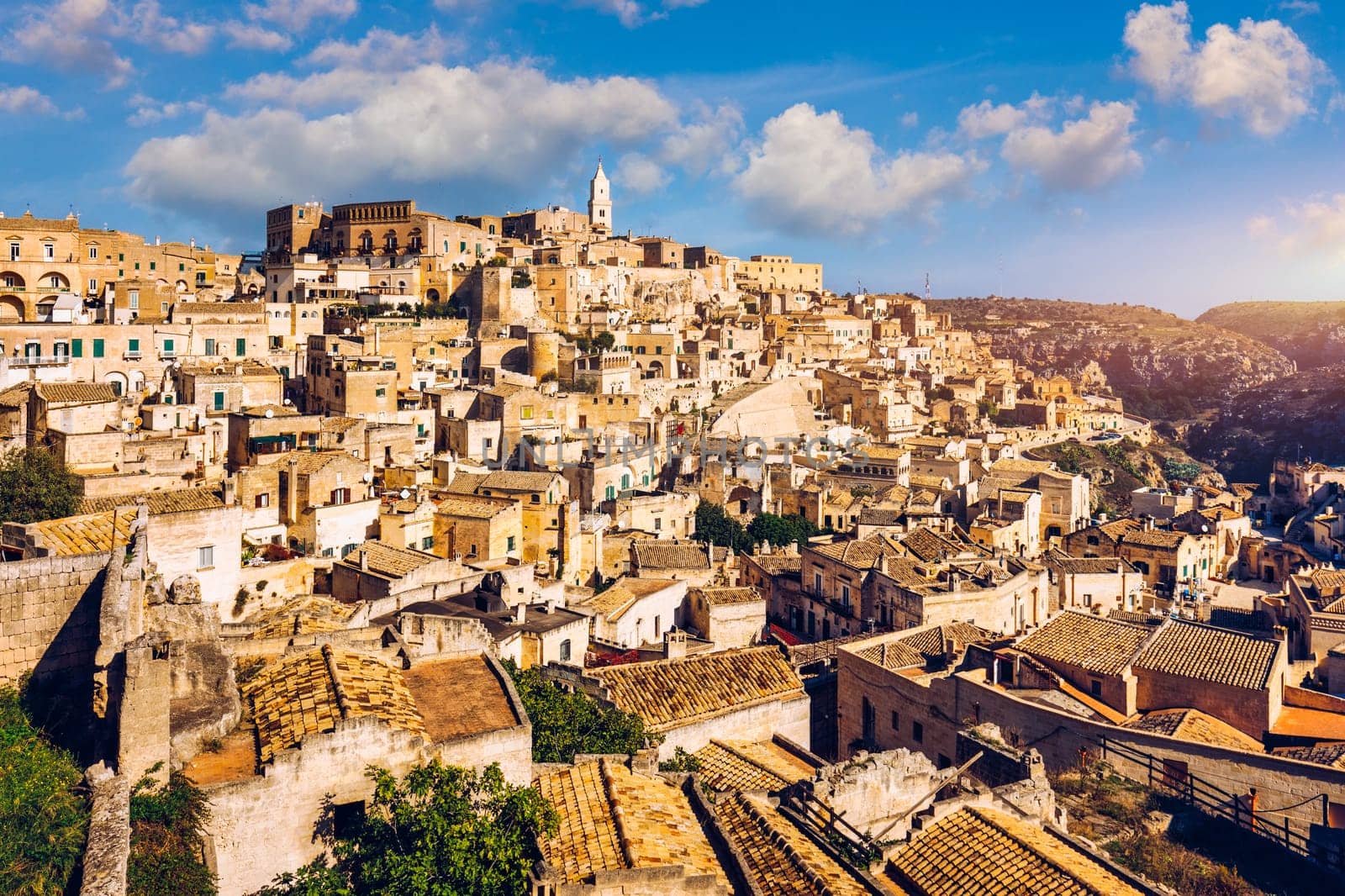 Panoramic view of the ancient town of Matera (Sassi di Matera) in a beautiful autumn day, Basilicata, southern Italy. Stunning view of the village of Matera. Matera is a city on a rocky outcrop. by DaLiu