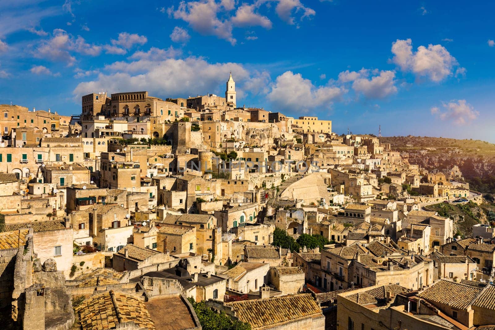 Panoramic view of the ancient town of Matera (Sassi di Matera) in a beautiful autumn day, Basilicata, southern Italy. Stunning view of the village of Matera. Matera is a city on a rocky outcrop. by DaLiu