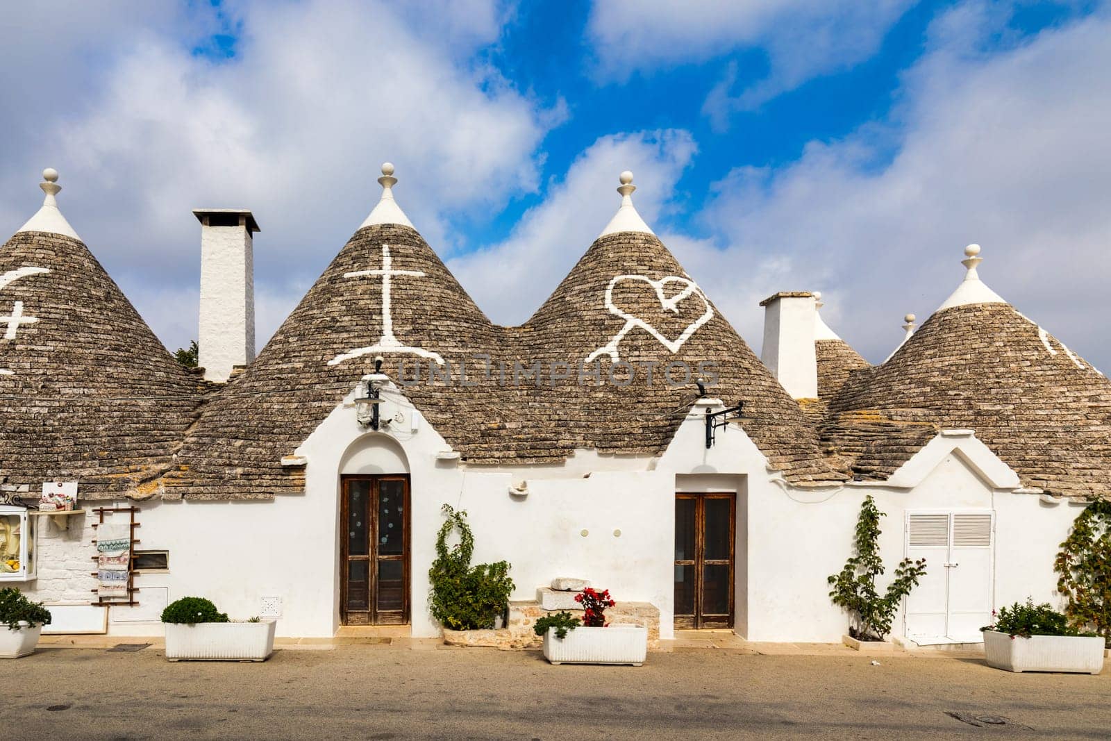 The traditional Trulli houses in Alberobello city, Apulia, Italy. Cityscape over the traditional roofs of the Trulli, original and old houses of this region, Apulia, Alberobello, Puglia, Italy.  by DaLiu