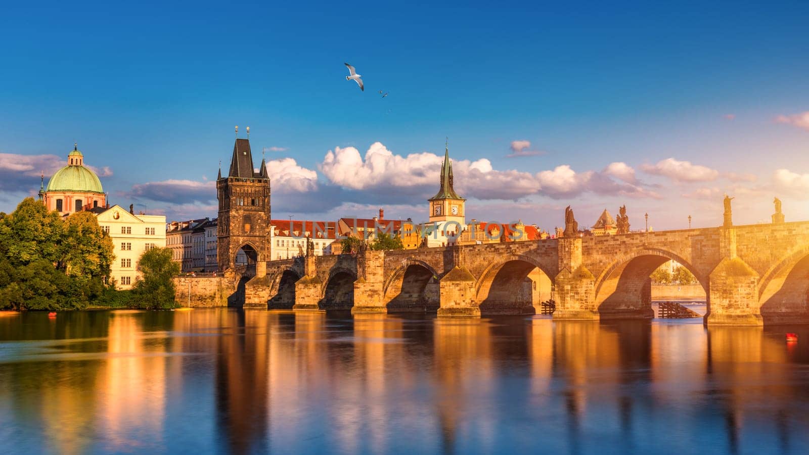 Charles Bridge in Prague in Czechia. Prague, Czech Republic. Charles Bridge (Karluv Most) and Old Town Tower. Vltava River and Charles Bridge. Concept of world travel, sightseeing and tourism.