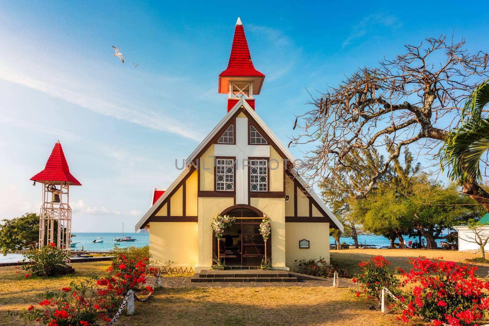 Red church at Cap Malheureux village, Mauritius Island. Notre Dame de Auxiliatrice, rural church with red roof in Cap Malheureux tropical village on Mauritius island, Indian Ocean.