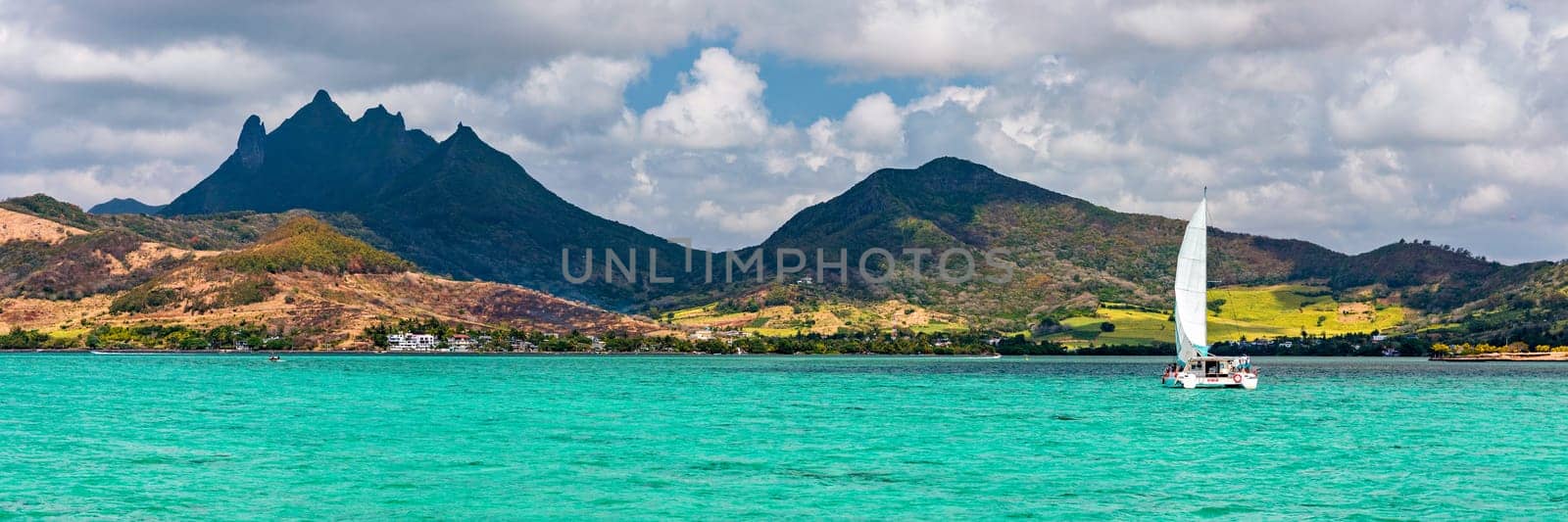 Beautiful catamaran in the paradise turquoise lagoon of the east coast of Mauritius. View of the lagoon of Mauritius in the Indian Ocean. 