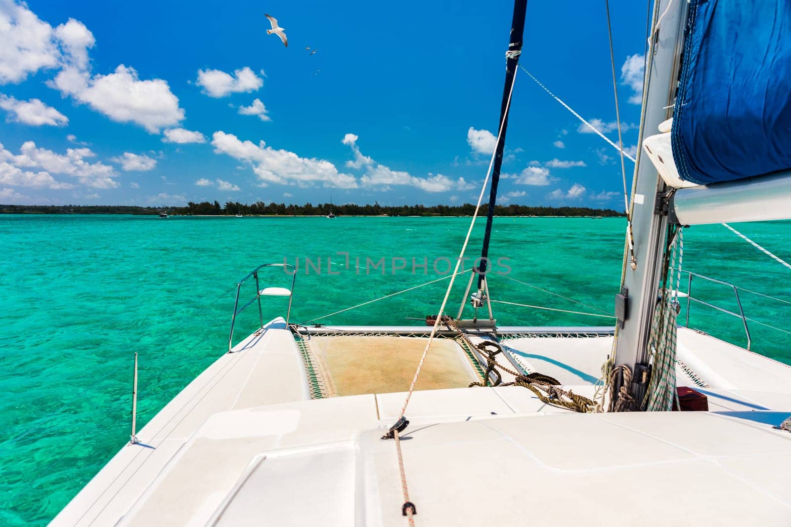 Beautiful catamaran in the paradise turquoise lagoon of the east coast of Mauritius. View of the lagoon of Mauritius in the Indian Ocean. 