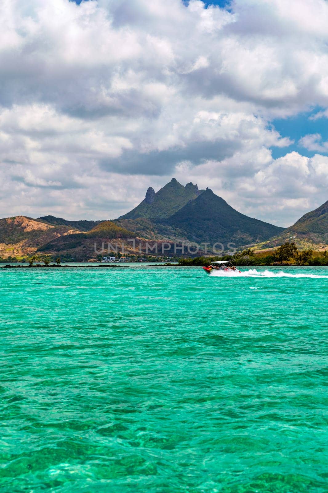 Beautiful catamaran in the paradise turquoise lagoon of the east coast of Mauritius. View of the lagoon of Mauritius in the Indian Ocean. 