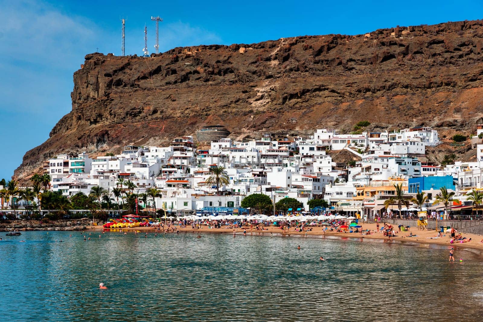 Puerto de Mogan with the beach in Gran Canaria, Spain. Favorite vacation place for tourists and locals on island. Harbor in Puerto de Mogan and Playa Mogan on Grand Canary Island, Spain.