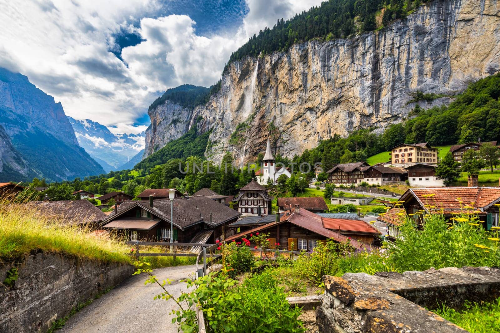 Famous Lauterbrunnen town and Staubbach waterfall, Bernese Oberland, Switzerland, Europe. Lauterbrunnen valley, Village of Lauterbrunnen, the Staubbach Fall, and the Lauterbrunnen Wall in Swiss Alps.