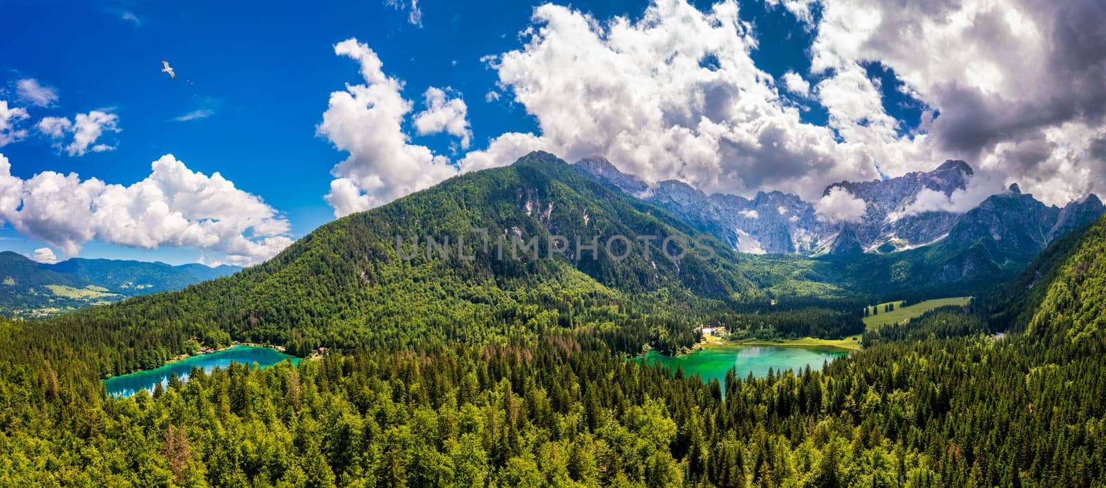 Picturesque lake Lago Fusine in Italy. Fusine lake with Mangart peak on background. Popular travel destination of Julian Alps. Location: Tarvisio comune , Province of Udine, Italy, Europe.