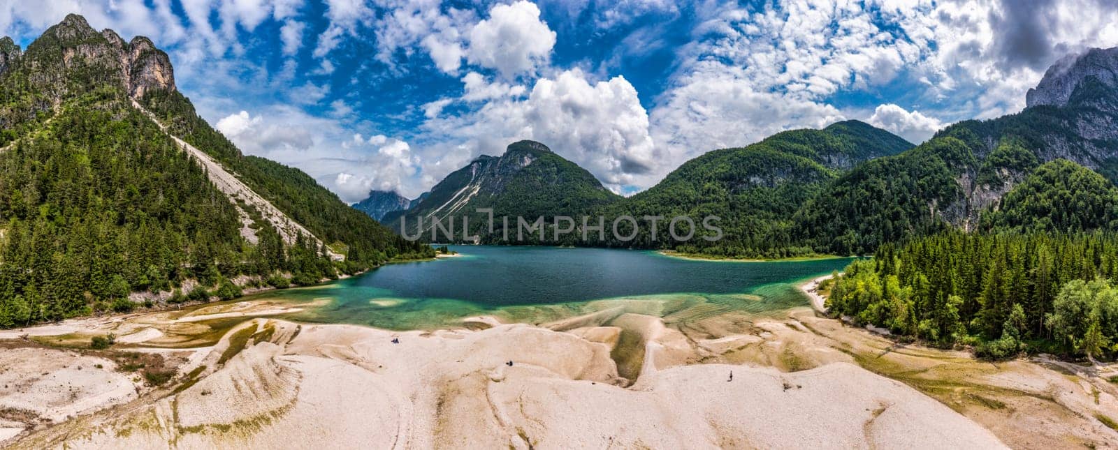 View to Julian Alps mountains above Predil lake in Italy with small lake. Predil Lake, Friuli Italy / (Lago del Predil), beautiful alpine lake in north Italy near the Slovenian border, Italy.