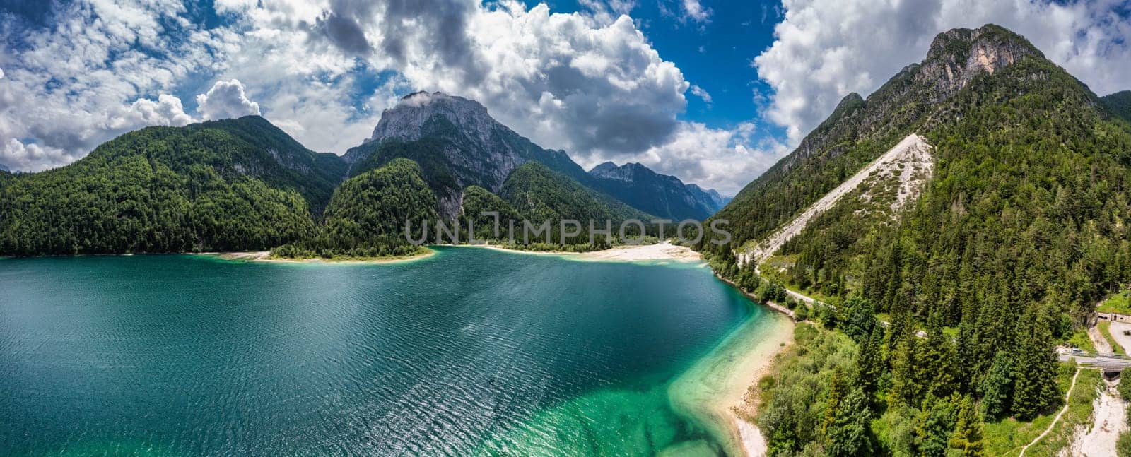 View to Julian Alps mountains above Predil lake in Italy with small lake. Predil Lake, Friuli Italy / (Lago del Predil), beautiful alpine lake in north Italy near the Slovenian border, Italy.