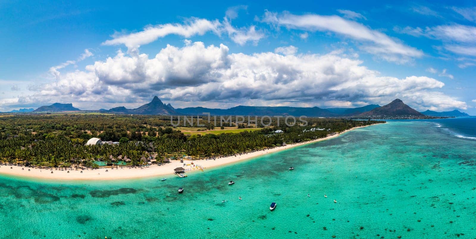 Mauritius, Black River, Flic-en-Flac, Aerial view of coastal beach in summer with Tourelle du Tamarin mountain in distant background. Mauritius island with gorgeous beach Flic en flac.