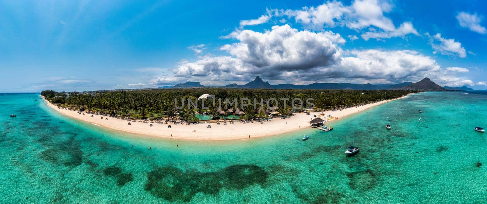 Mauritius, Black River, Flic-en-Flac, Aerial view of coastal beach in summer with Tourelle du Tamarin mountain in distant background. Mauritius island with gorgeous beach Flic en flac.