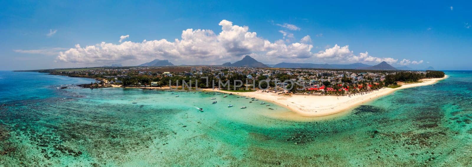 Beautiful Mauritius Island with gorgeous beach Flic en Flac, aerial view from drone. Mauritius, Black River, Flic-en-Flac view of oceanside village beach and luxurious hotel in summer.