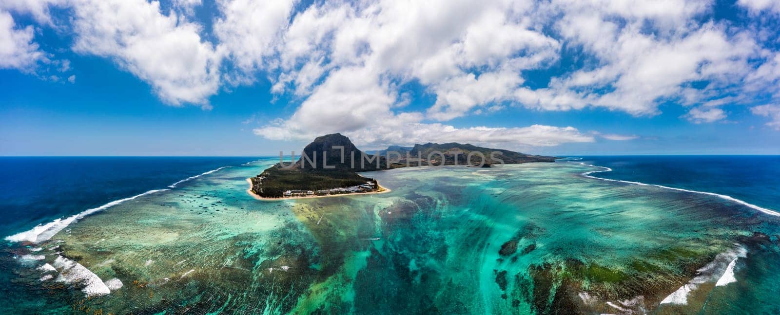 Aerial view of Mauritius island panorama and famous Le Morne Brabant mountain, beautiful blue lagoon and underwater waterfall. Le Morne Brabant peninsula and Underwater Waterfall, Mauritius.