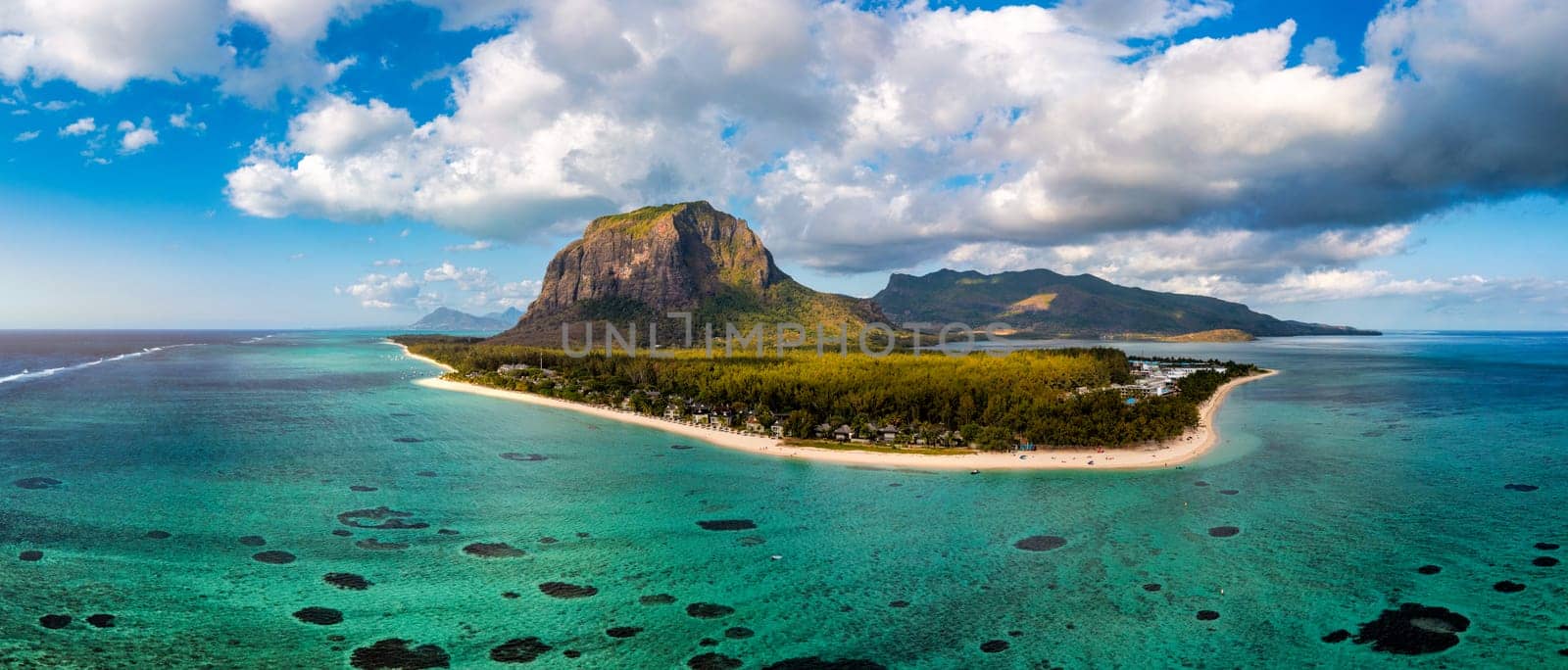 Aerial view of Le morne Brabant in Mauriutius. Tropical crystal ocean with Le Morne mountain and luxury beach in Mauritius. Le Morne beach with palm trees, white sand and luxury resorts, Mauritius.