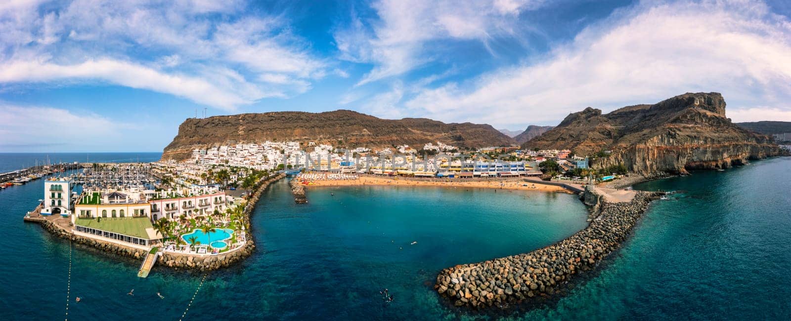 Puerto de Mogan with the beach in Gran Canaria, Spain. Favorite vacation place for tourists and locals on island. Harbor in Puerto de Mogan and Playa Mogan on Grand Canary Island, Spain.