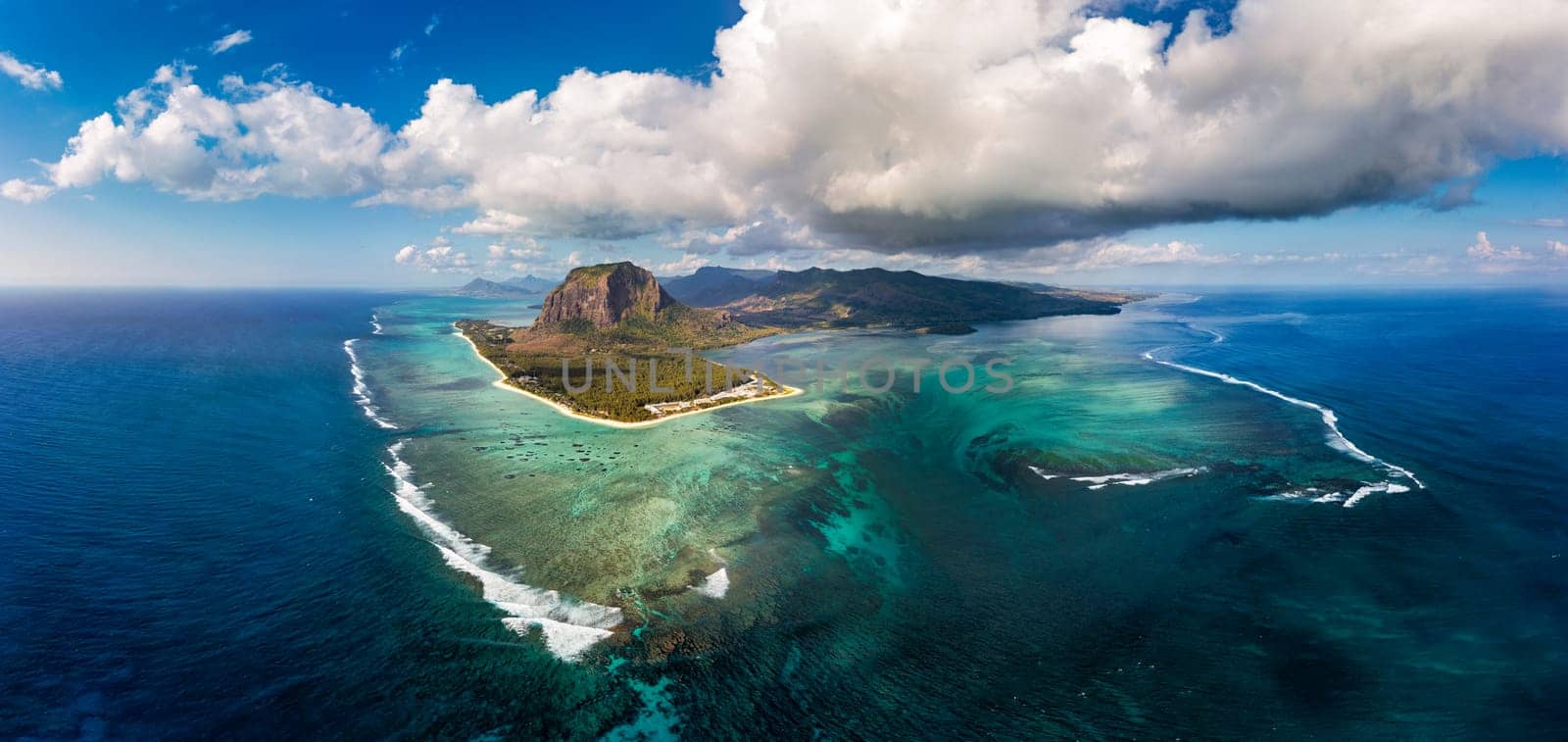 Aerial view of Mauritius island panorama and famous Le Morne Brabant mountain, beautiful blue lagoon and underwater waterfall. Le Morne Brabant peninsula and Underwater Waterfall, Mauritius.