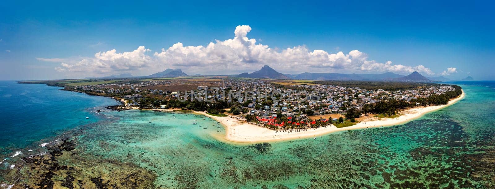 Beautiful Mauritius Island with gorgeous beach Flic en Flac, aerial view from drone. Mauritius, Black River, Flic-en-Flac view of oceanside village beach and luxurious hotel in summer.