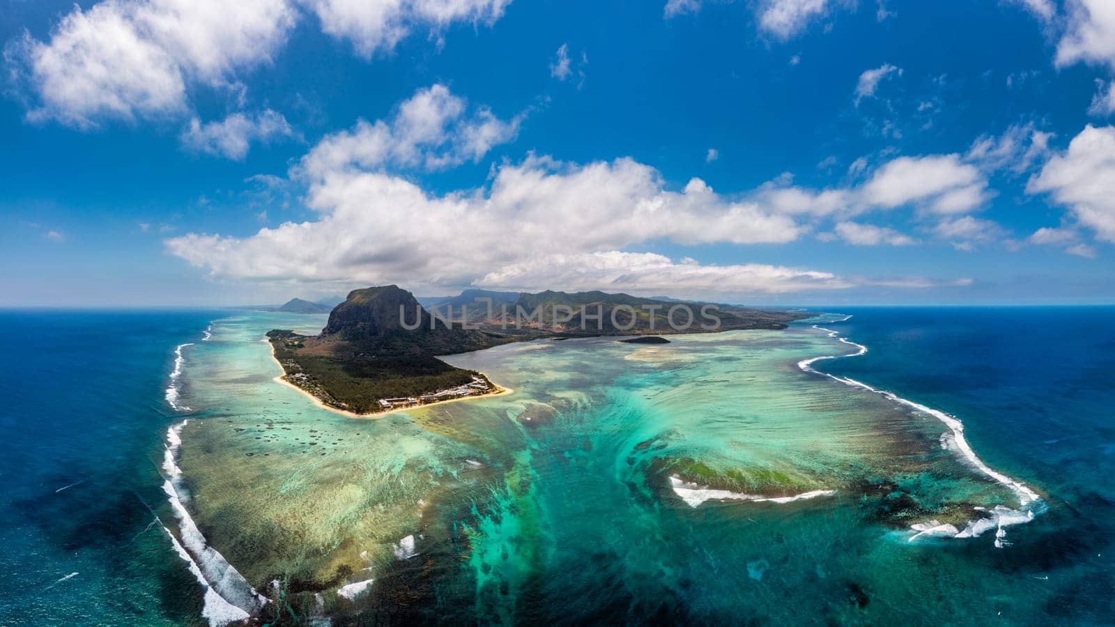 Aerial view of Mauritius island panorama and famous Le Morne Brabant mountain, beautiful blue lagoon and underwater waterfall. Le Morne Brabant peninsula and Underwater Waterfall, Mauritius.