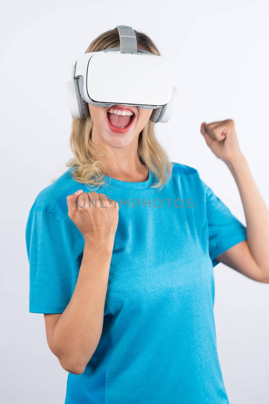 Caucasian happy girl making winner gesture while using VR glasses. Contraption. by biancoblue