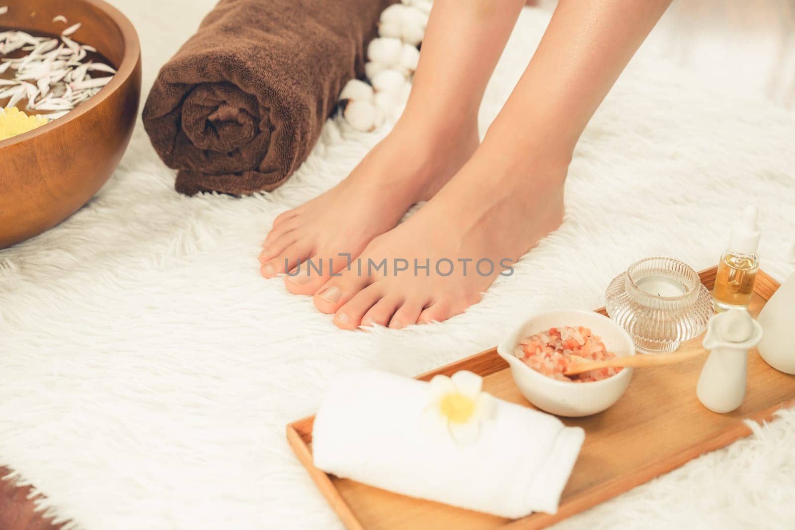 Panorama top view woman indulges in blissful foot massage at luxurious spa salon while masseur give reflexology therapy in gentle day light ambiance resort or hotel foot spa. Quiescent