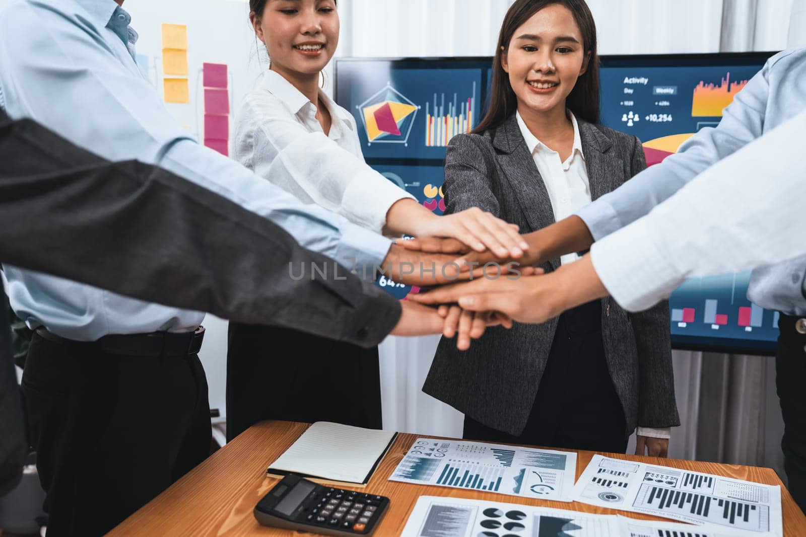 Multiracial office worker's hand stack shows solidarity, teamwork and trust in diverse community. Businesspeople unite for business success through synergy and collaboration by hand stacking. Concord