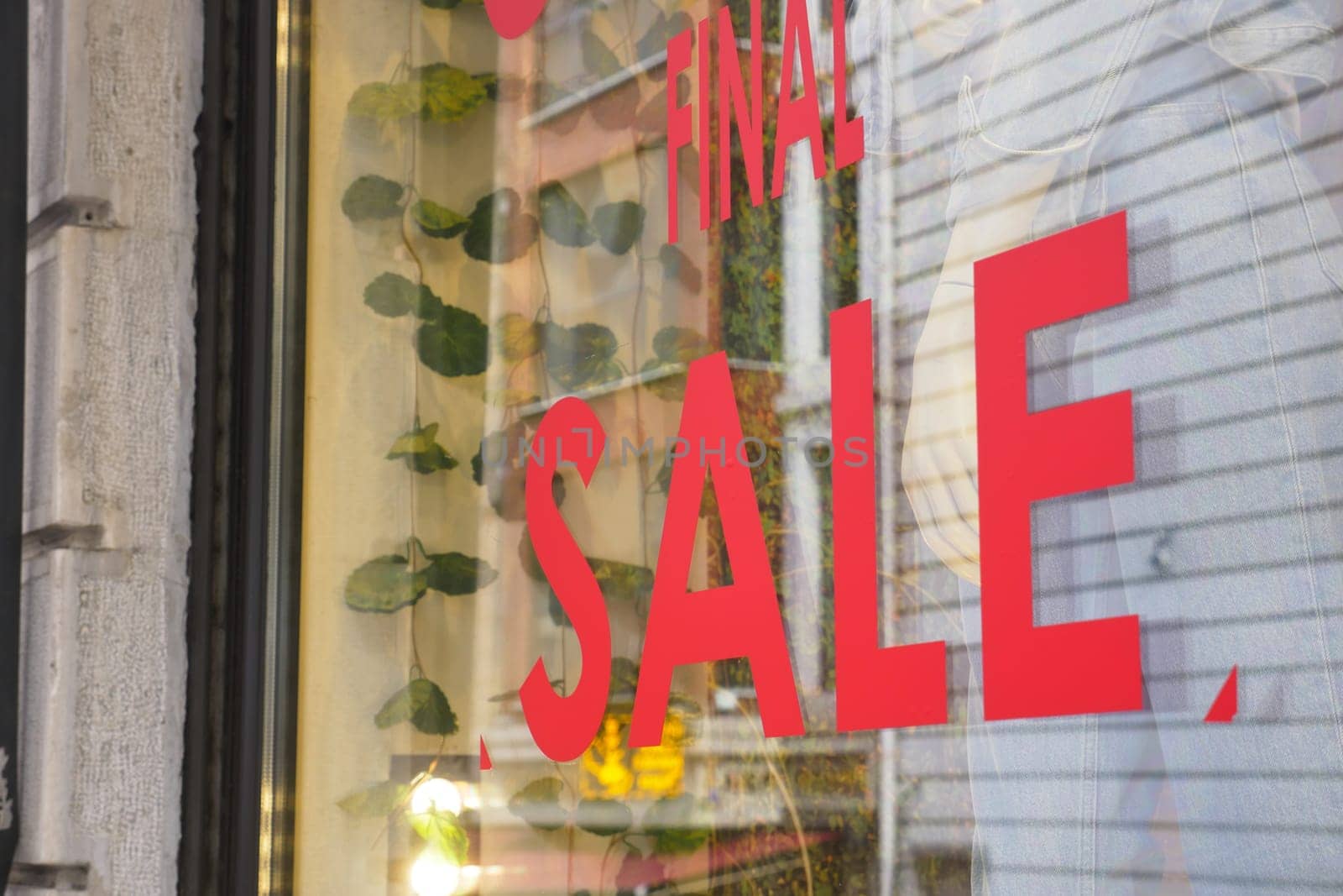 Large red Sale text letters on red background on clothing store