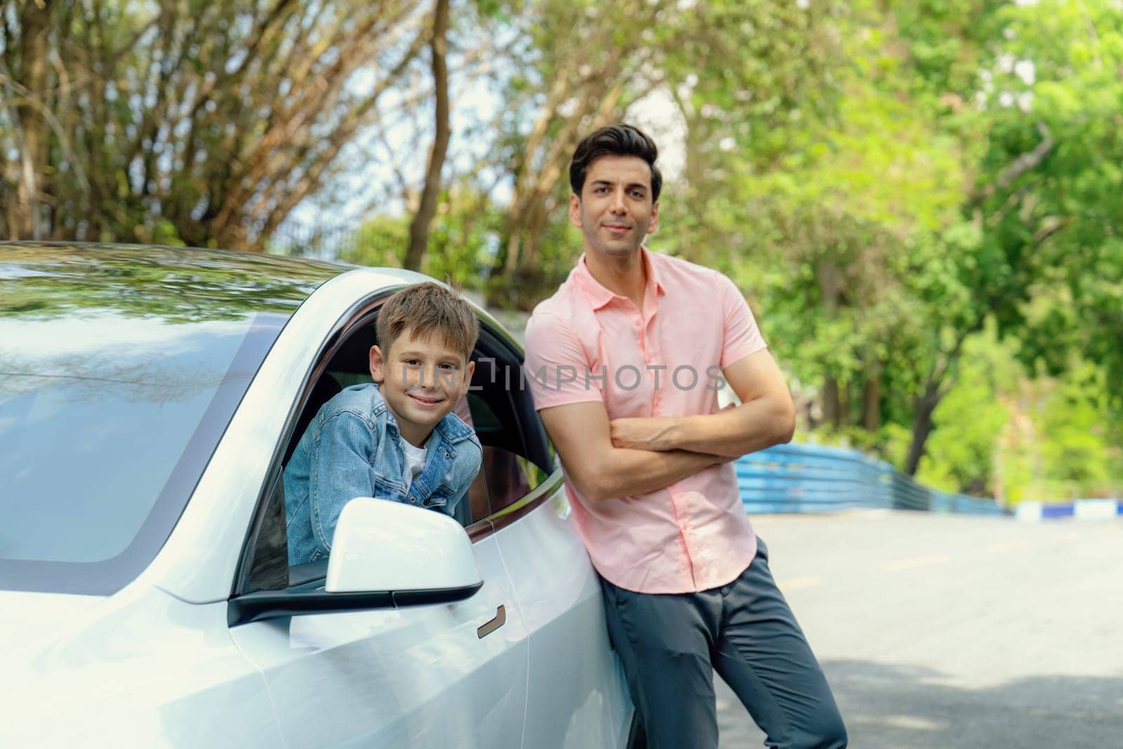 Dad and son on the road trip by the green nature countryside, family vholiday vacation concept. Young little boy enjoying family car adventure vacation with his father. Perpetual