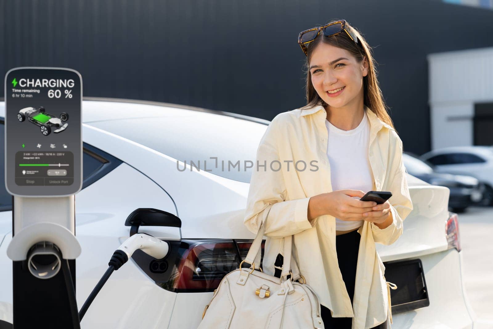 Young woman holding shopping bag recharge EV car. Expedient by biancoblue