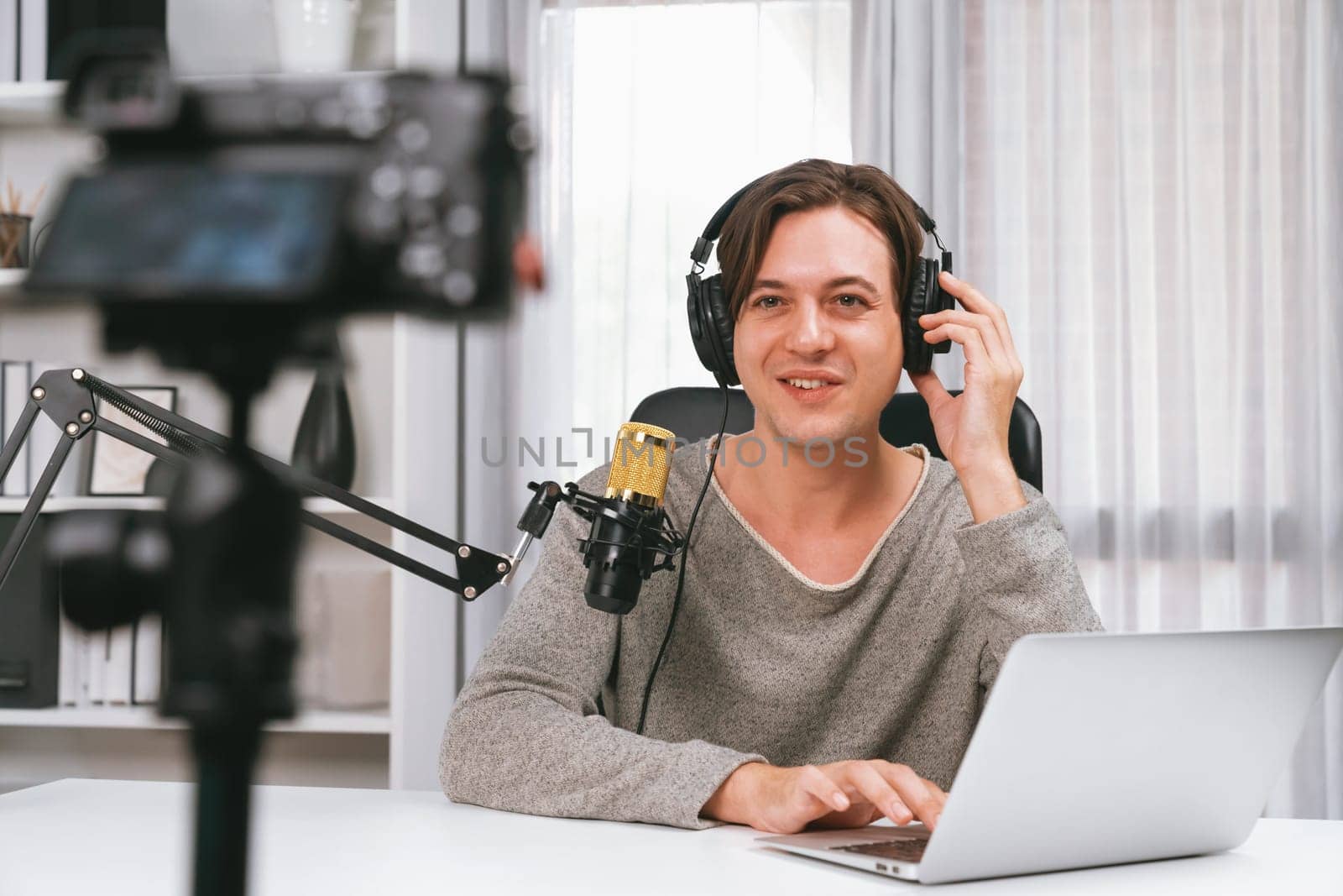 Host channel in smart broadcaster recording by camera with talking show on live social media, broadcasting on social media, wearing headphones to record video streamer at modern studio. Pecuniary.