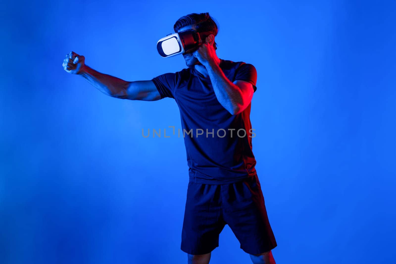 Side view of smart man wearing VR glass and smashing or punching at camera. Sport gamer boxing and moving gesture in metaverse or virtual world while using digital technology innovation. Deviation.
