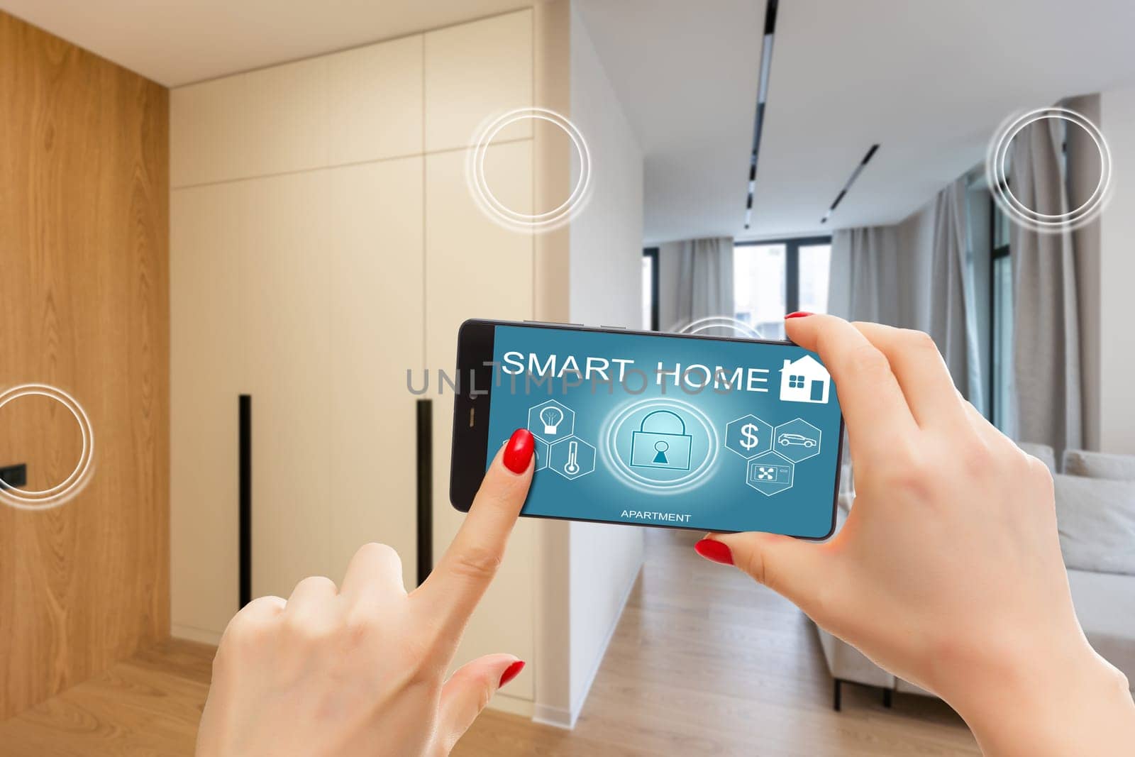 Close up smartphone in female hand with smart home system app interface on cellphone screen, young woman controlling all house system by phone in modern apartment, internet of things concept. by Andelov13