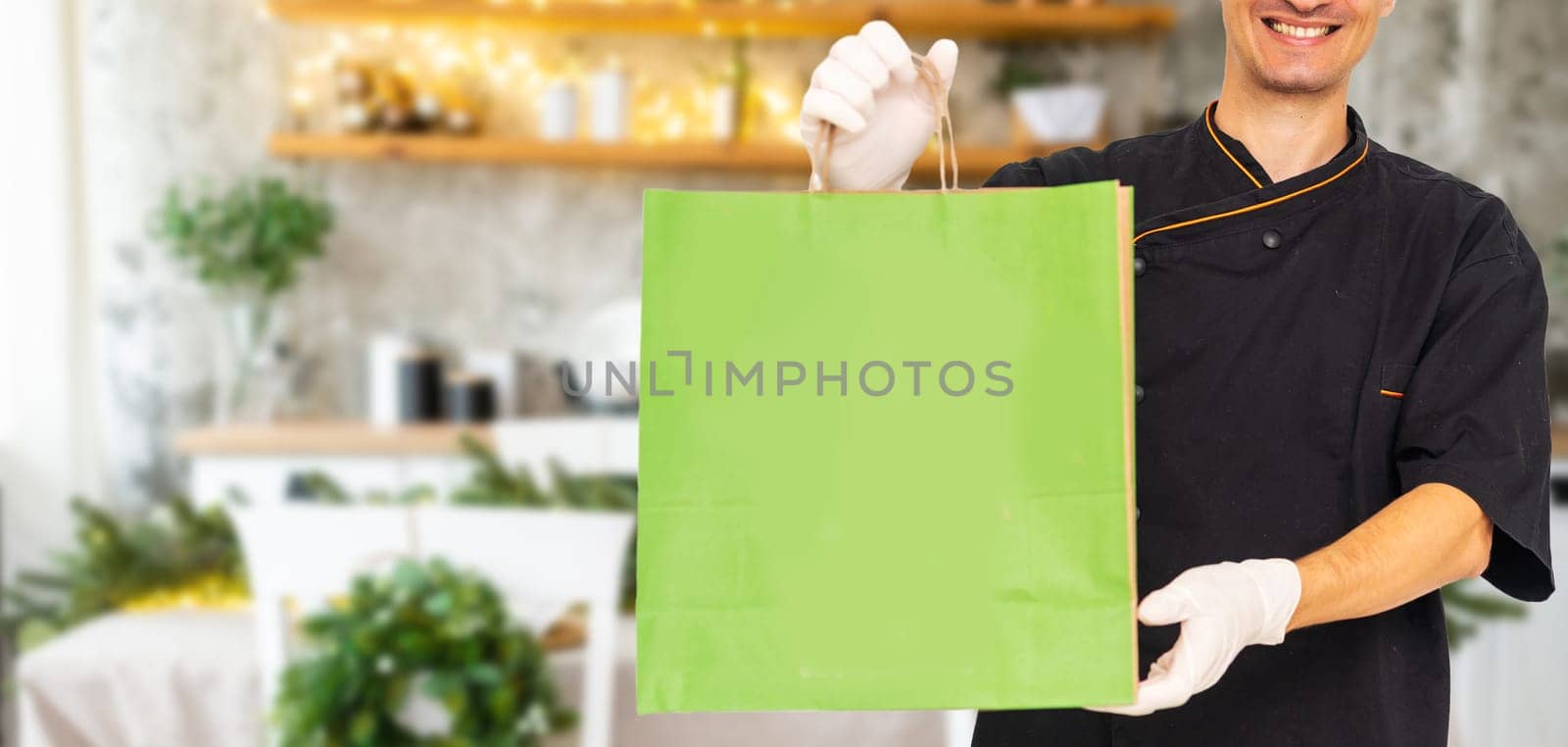 Diverse of paper containers for takeaway food. Delivery man is carrying pizza.