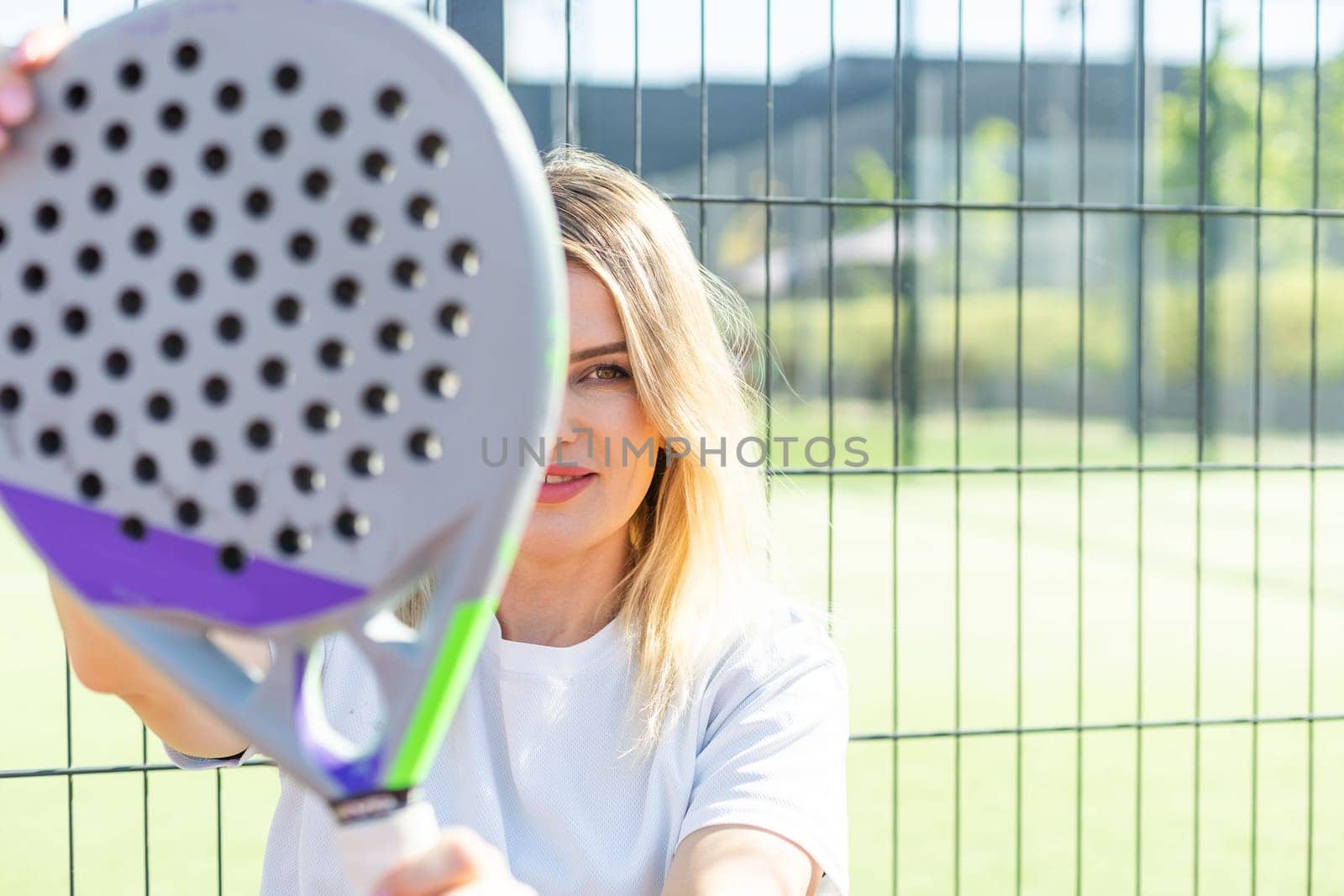 A female paddle tennis player after playing a match. High quality photo