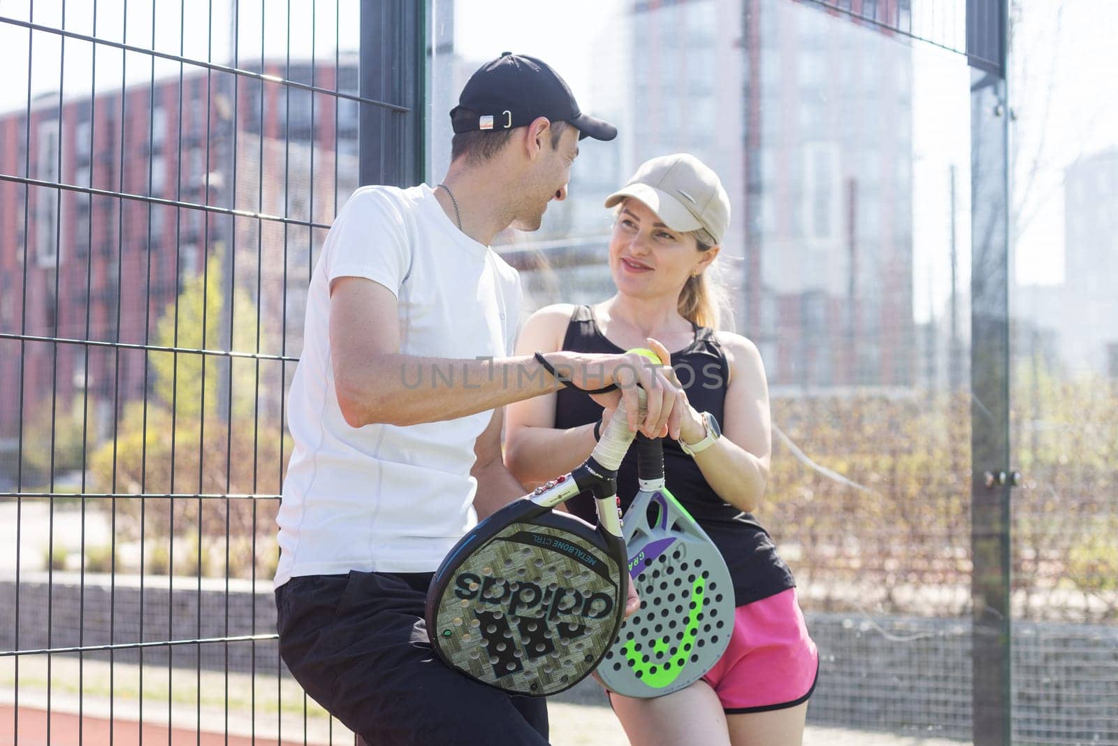 Ukraine Kyiv, April 02 2024. Padel training coach in a session, mentoring a female student, fostering skill development and a positive learning environment by Andelov13