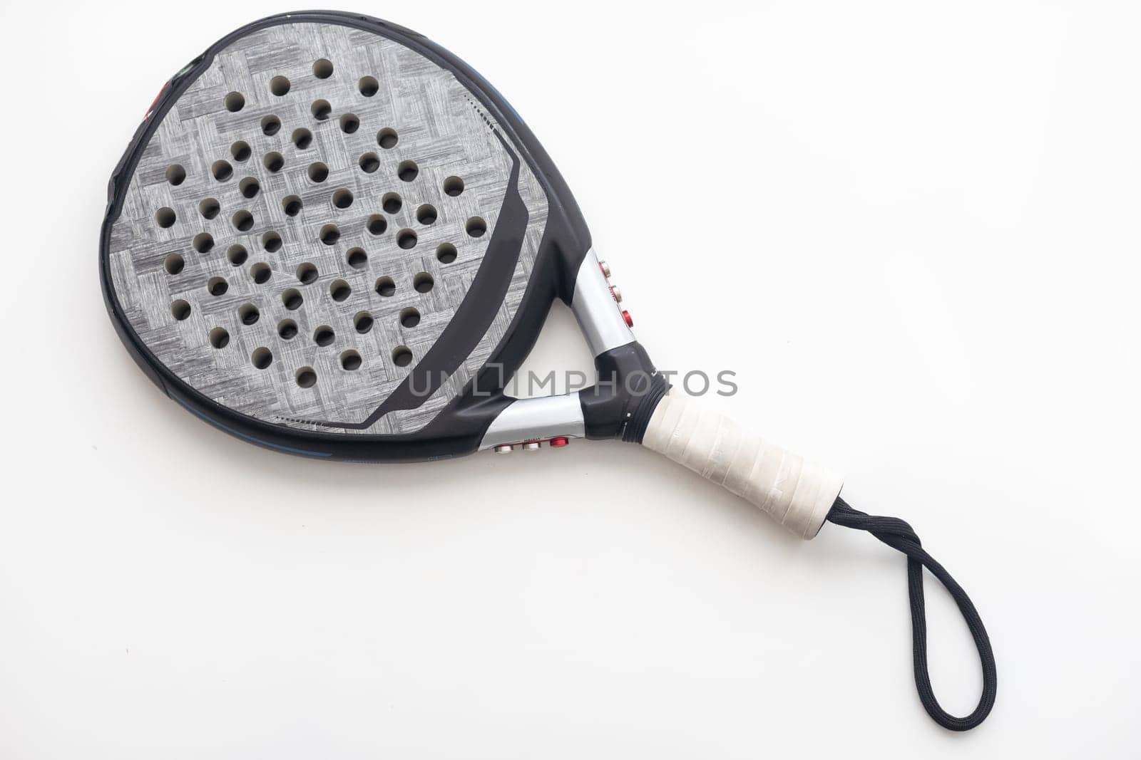 Set of paddle tennis rackets and balls the reflected on white table and white isolated background. Front view. High quality photo