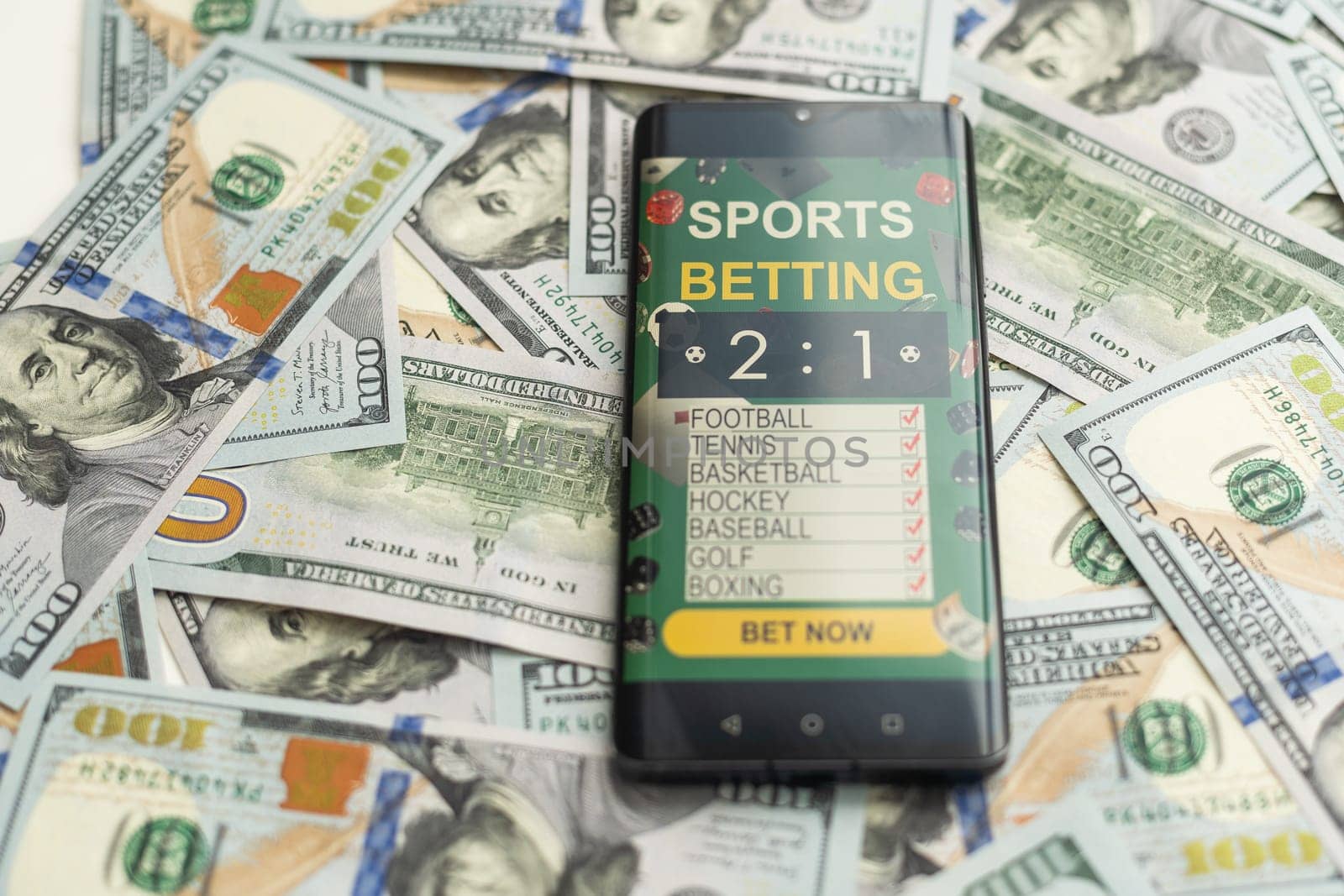 dollars and euros, smartphone with sports bet application. High quality photo