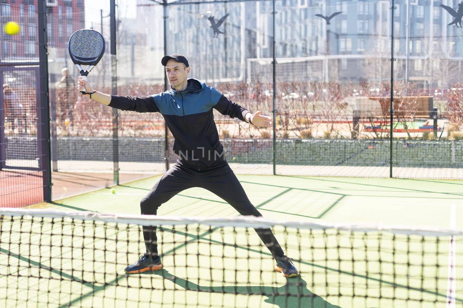 Man playing paddle tennis. Jumping and shooting the ball. High quality photo