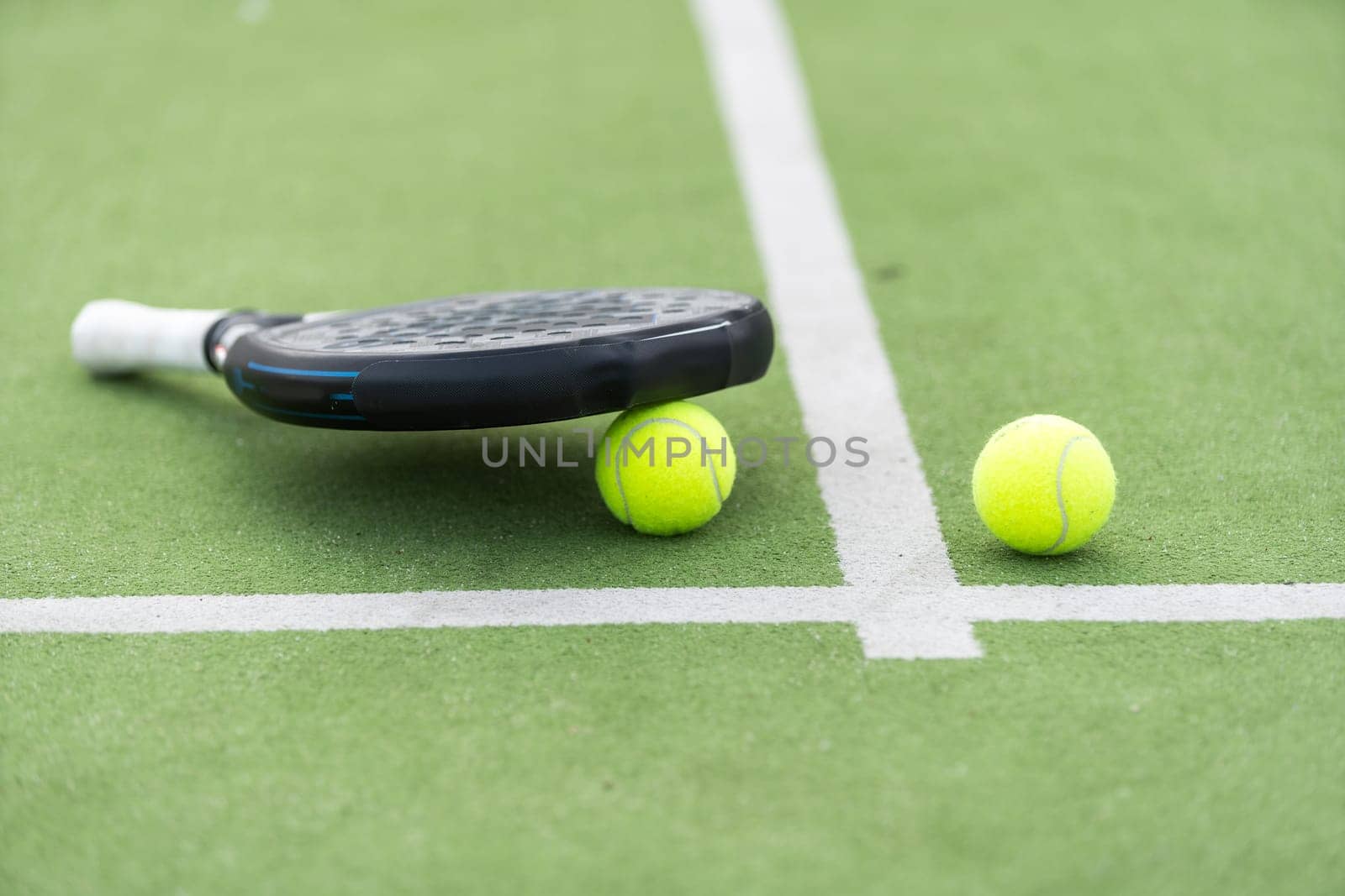 White professional paddle tennis racket with natural lighting on blue background. Horizontal sport theme poster, greeting cards, headers, website and app. High quality photo