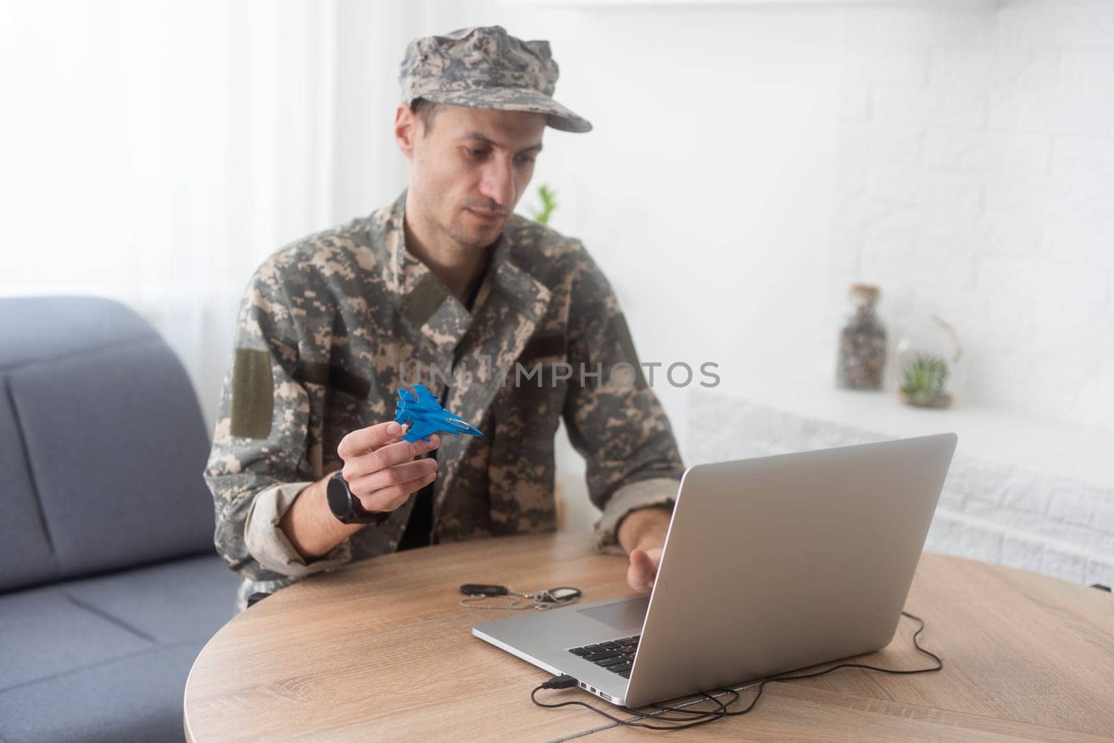 military man holding model fighter plane. High quality photo