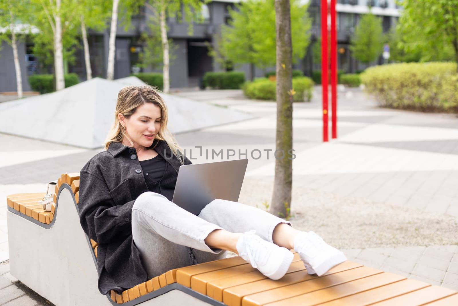 Businesswoman working with laptop in outdoor cafe. Corporate blog. High quality photo