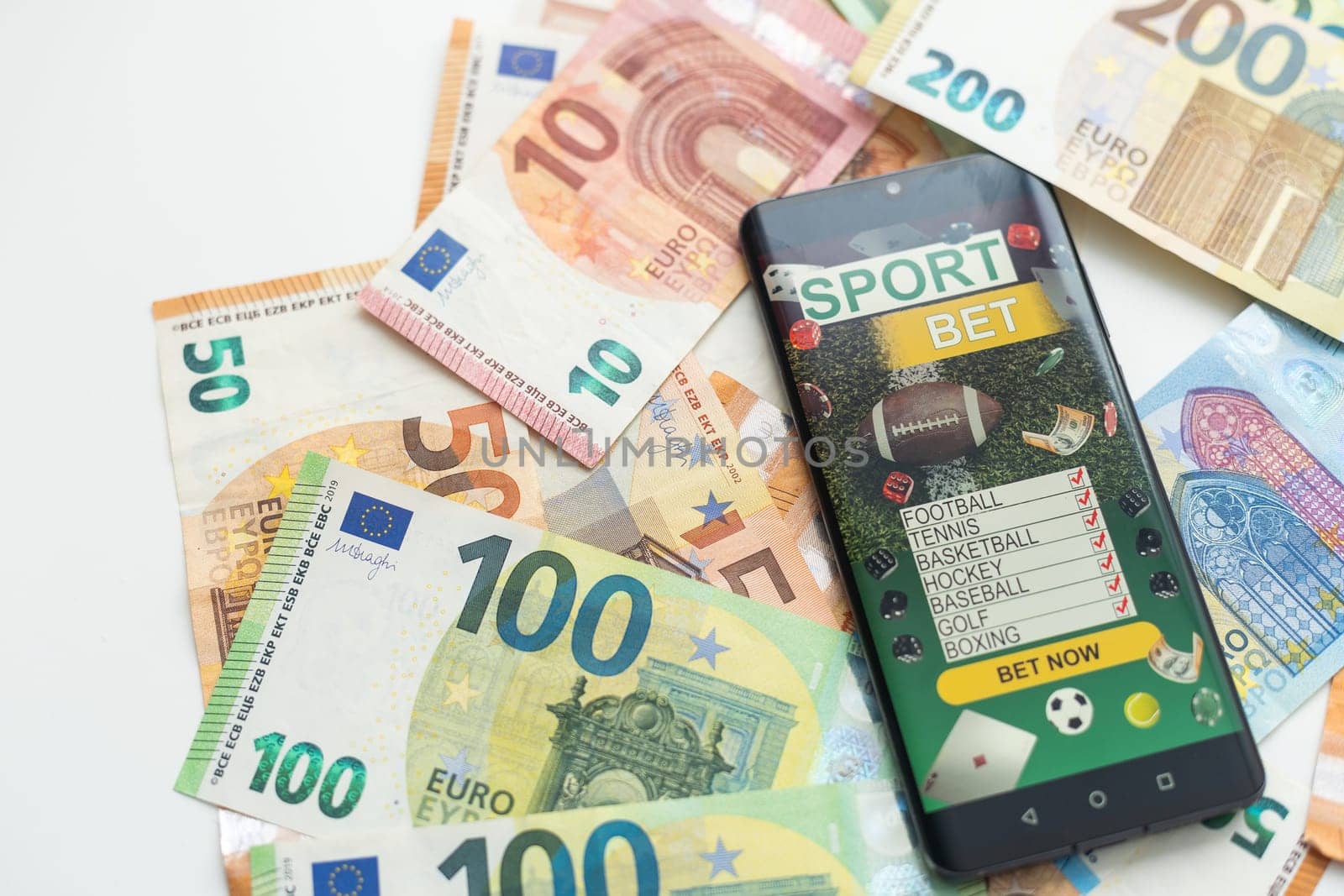 betting on sports, smart phone with working online betting mobile application. High quality photo