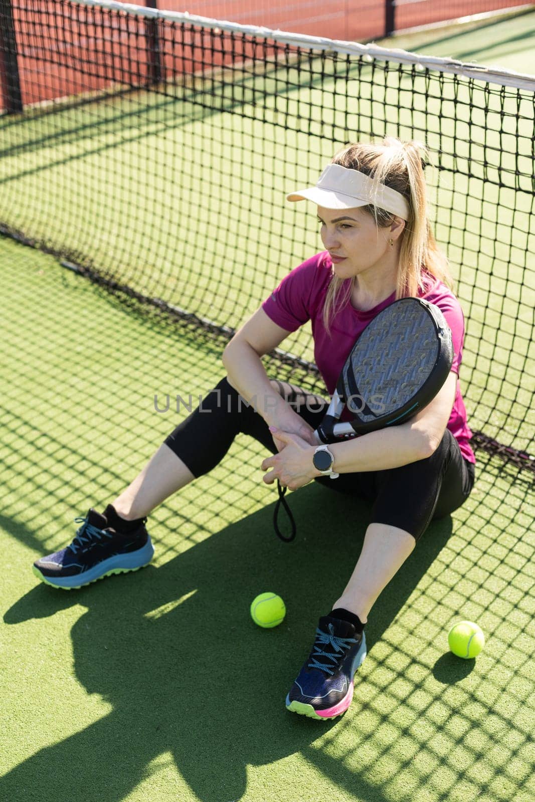 Portrait of attractive woman padel tennis player in outdoor court. High quality photo