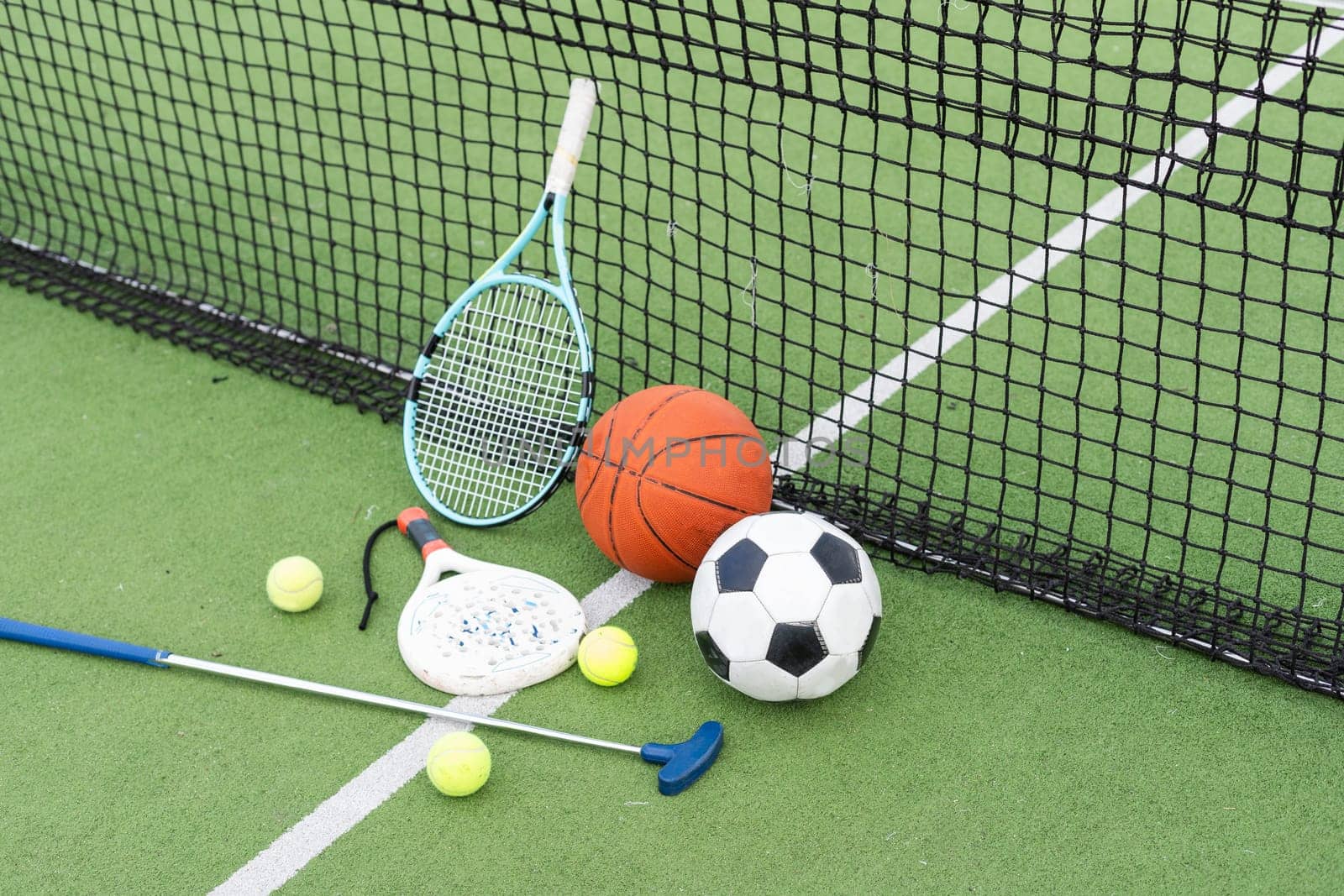 A group of sports equipment on background including tennis, basketball, and soccer on a background with copy space by Andelov13