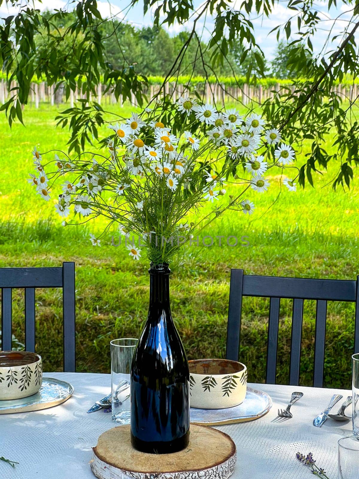 Wedding table set up in boho style with flowers near to vineyard. High quality photo