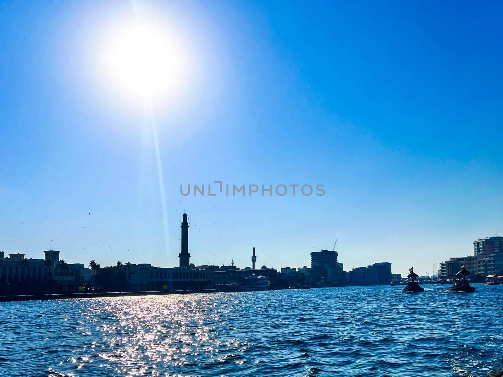 Stylish panoramicview of the historic part of Dubai, against the sun with ships by stan111
