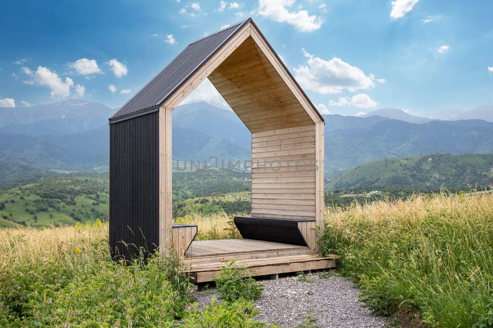 Wooden gazebo with benches for romantic weekend dating in mountains.