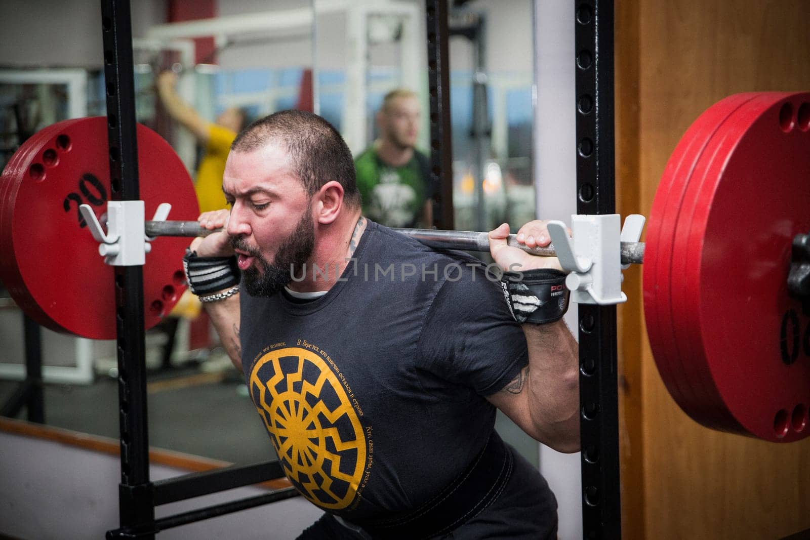 Bila Tserkva, Ukraine, October 15, 2016: Man squats with a barbell in the gym