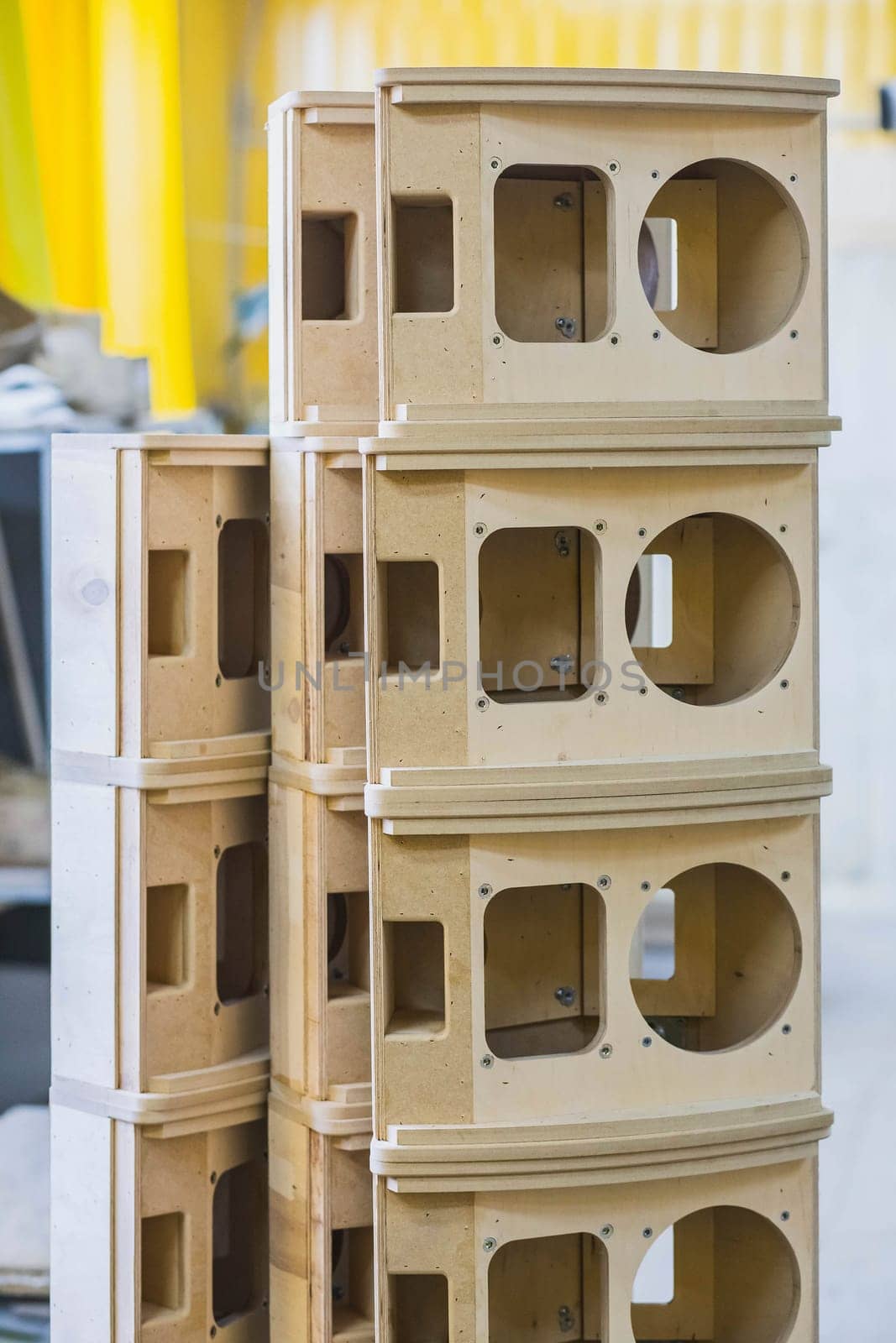 wooden bases Audio Speakers stacked like a tower at the factory.
