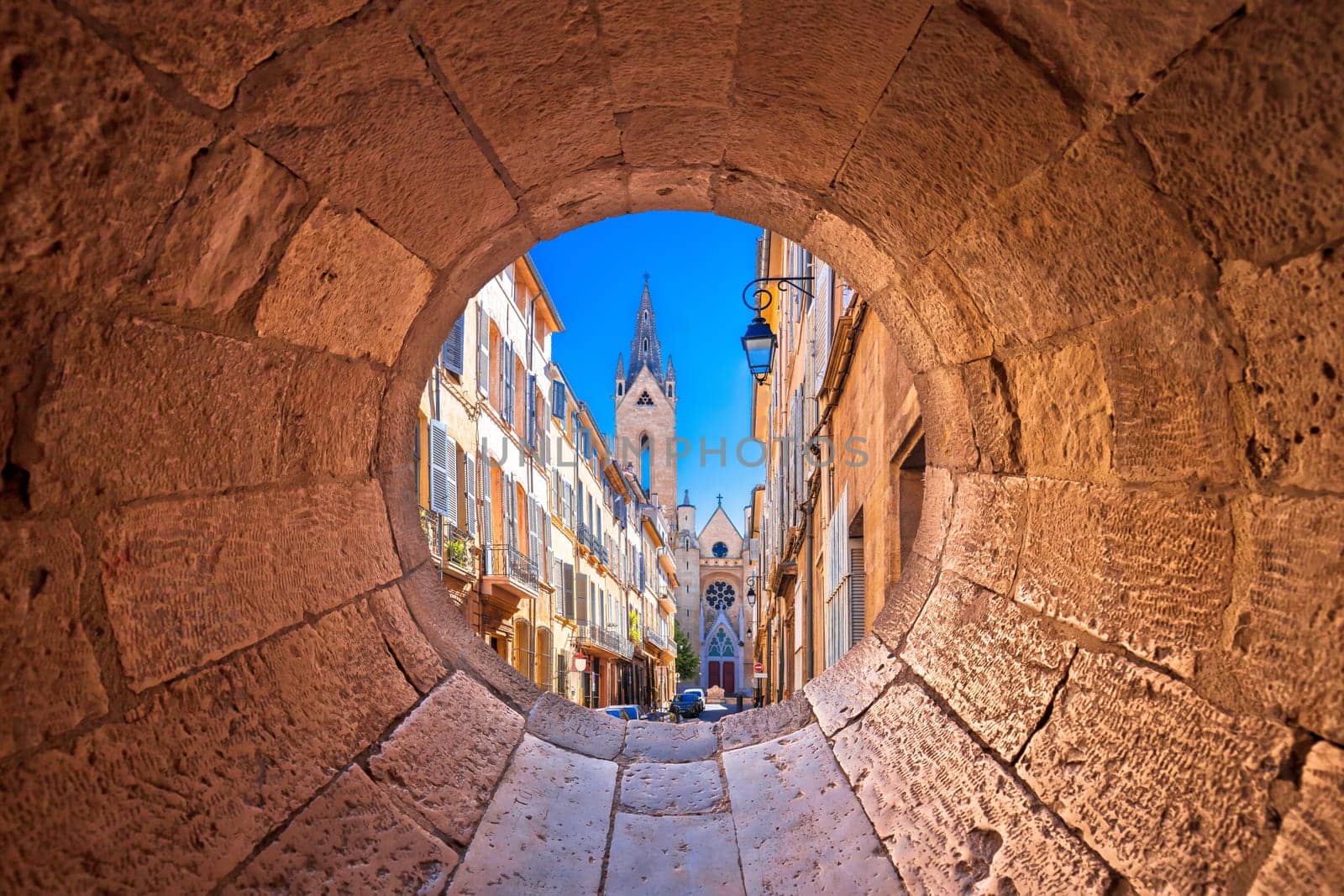 Aix En Provence scenic alley and church view through stone window by xbrchx