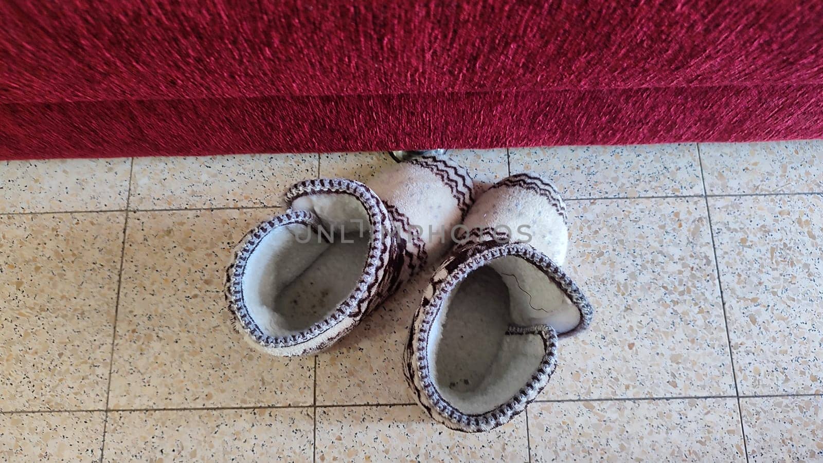 winter slippers made of wool stand on the floor, home page shoes. High quality photo